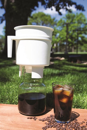 Picture of a Toddy Cold Brew System and a glass of Colorado Style Cold Brew Coffee